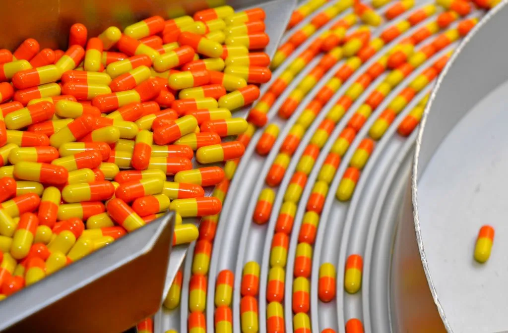 Drug capsules are pictured on a production line.&nbsp;