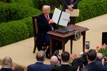 President Donald Trump signs an executive order imposing tariffs on imported goods during a&nbsp;trade announcement event in the Rose Garden at the White House on April 2.