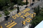 People walk down 16th street after “Defund The Police” was painted on the street near the White House on June 08, 2020 in Washington, DC.