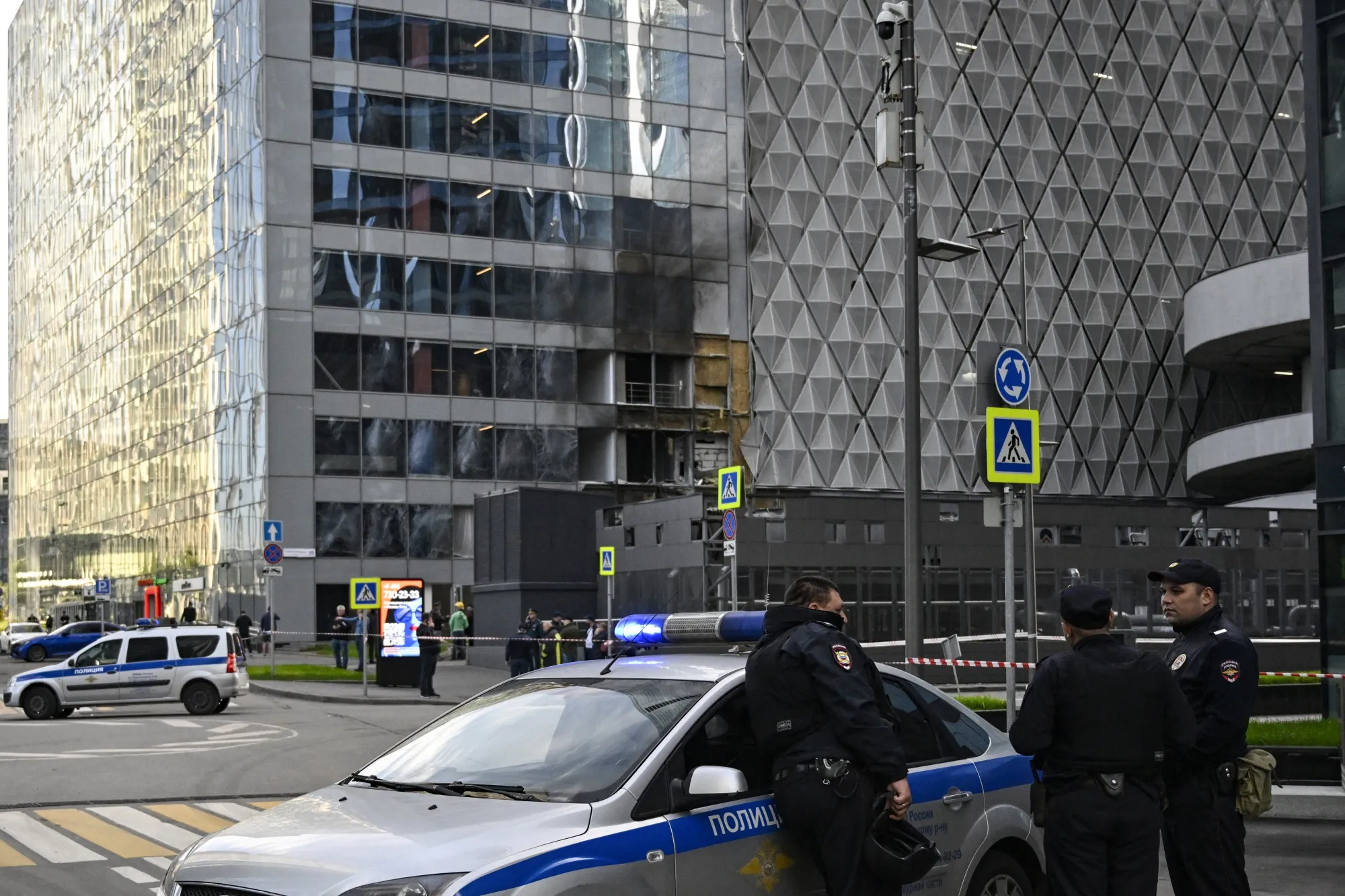 Police officers block off an area around a damaged office block of the Moscow International Business Center&nbsp;following a reported drone attack in Moscow on July 30.