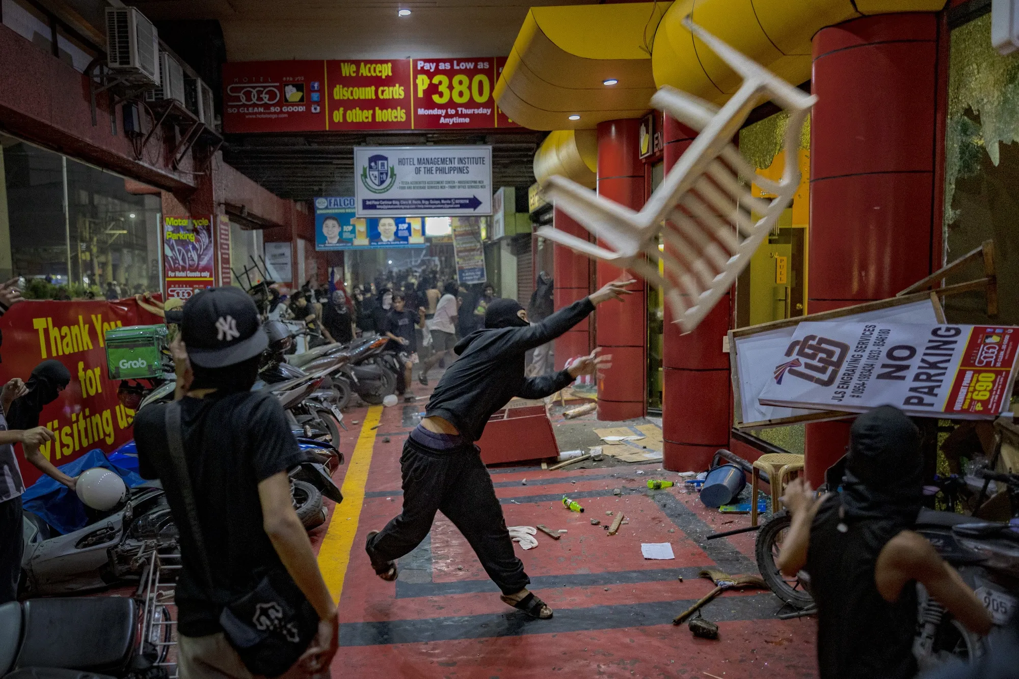 Filipinos attack a motel during anti-corruption demonstrations in Manila on Sept. 21.