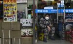 &nbsp;A man&nbsp;waits for customers in his shop&nbsp;in Beijing on Feb. 25.&nbsp;