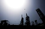 Workers unload liquefied natural gas in Karachi, Pakistan.