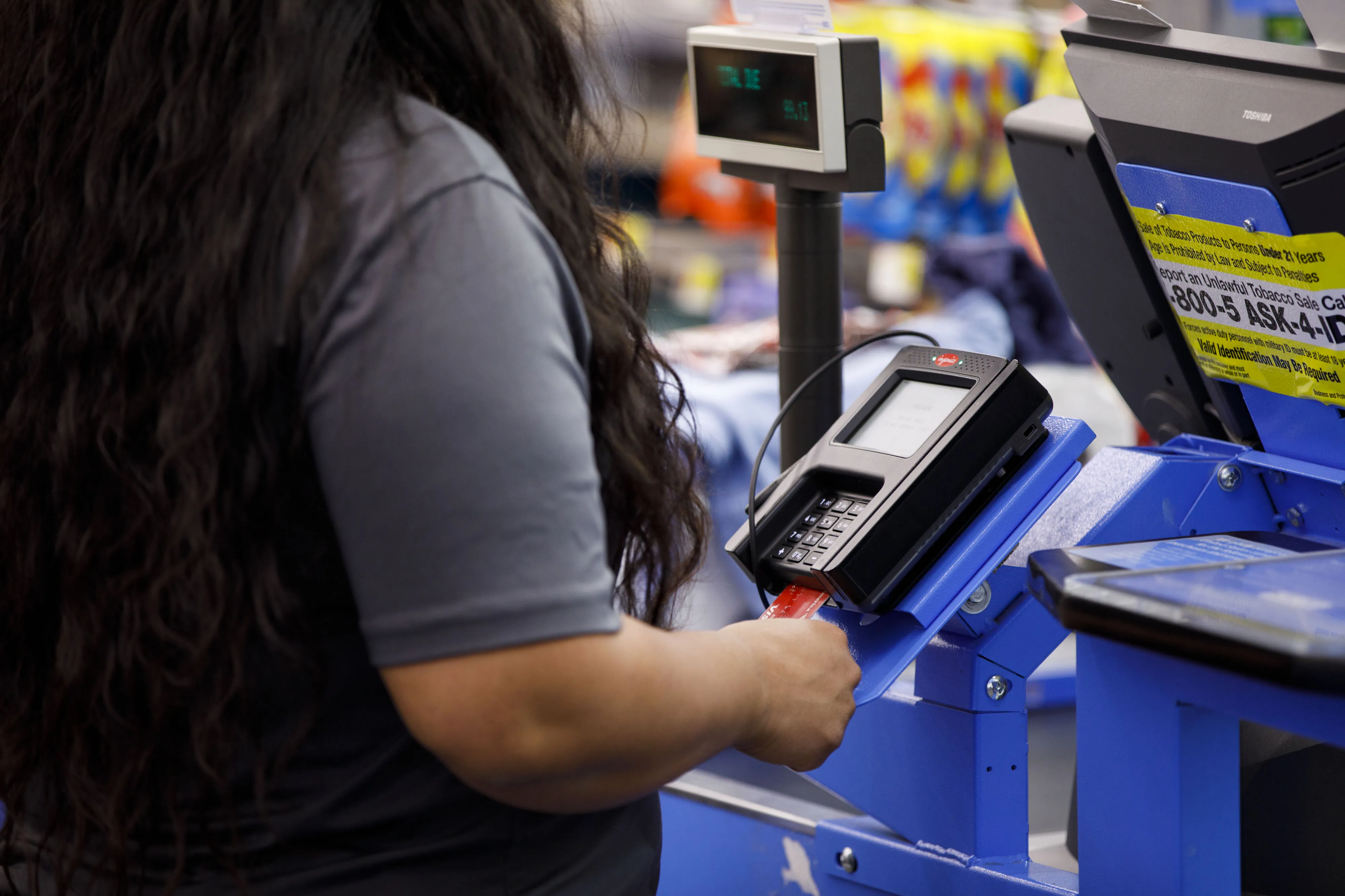 A customer uses a credit card terminal at a store.