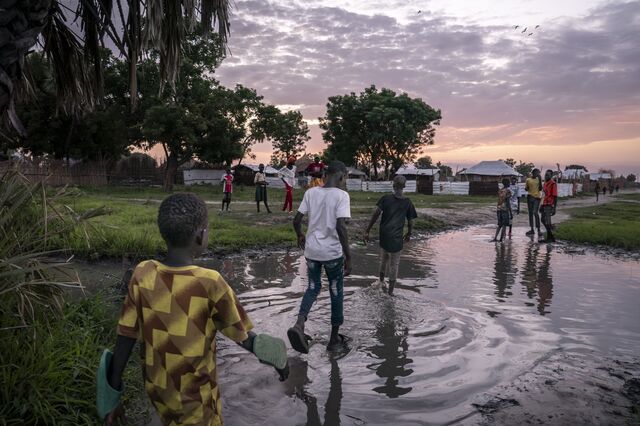 A flooded pathway in Koch town. During the rainy season, wastewateer overflows from the giant pits in which it is stored, contaminating nearby streams, ponds, canals and floodplains.