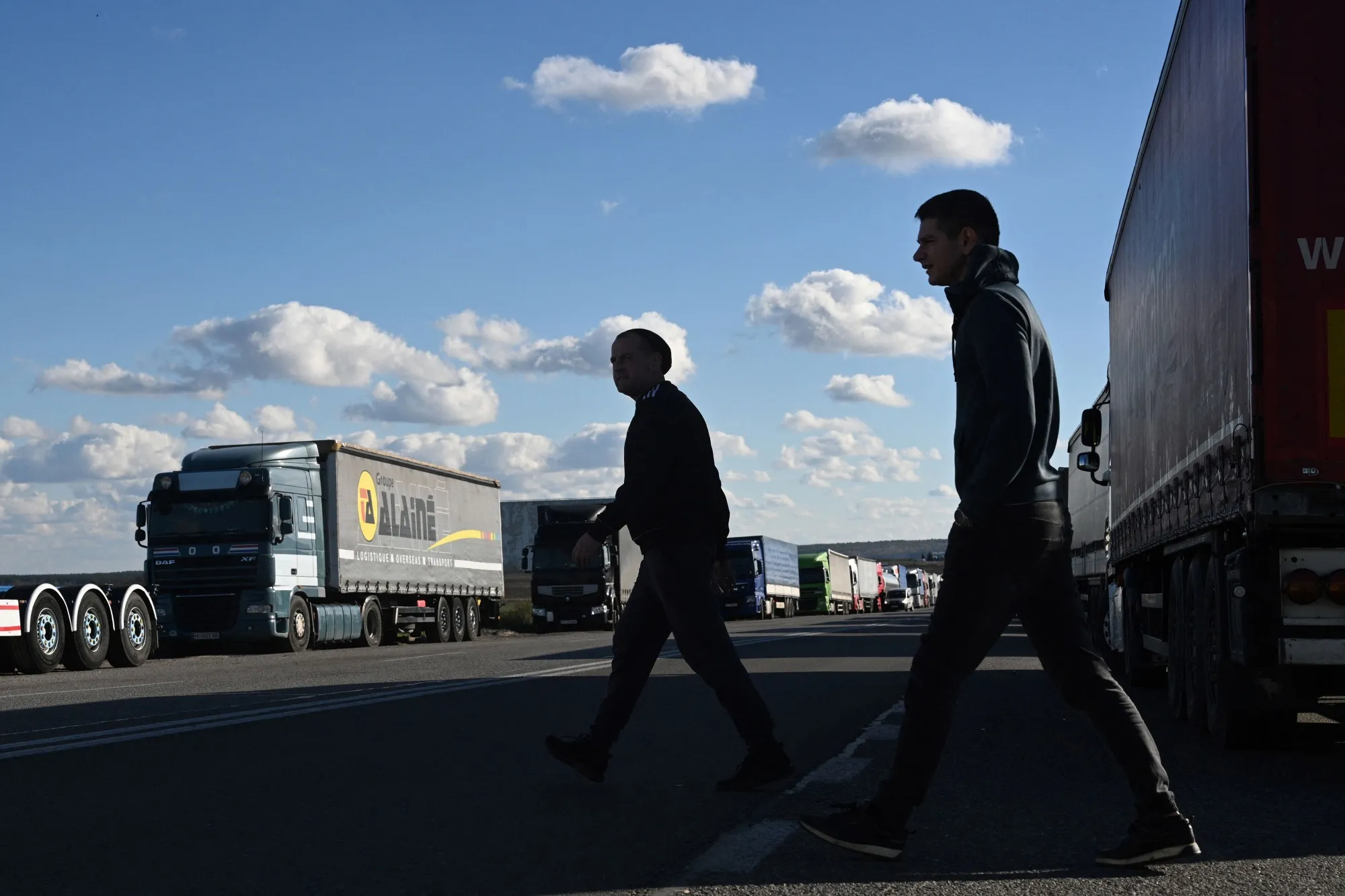 Driver walk among trucks waiting at the Rava-Ruska border checkpoint on the Ukrainian-Polish border&nbsp;on November 9.