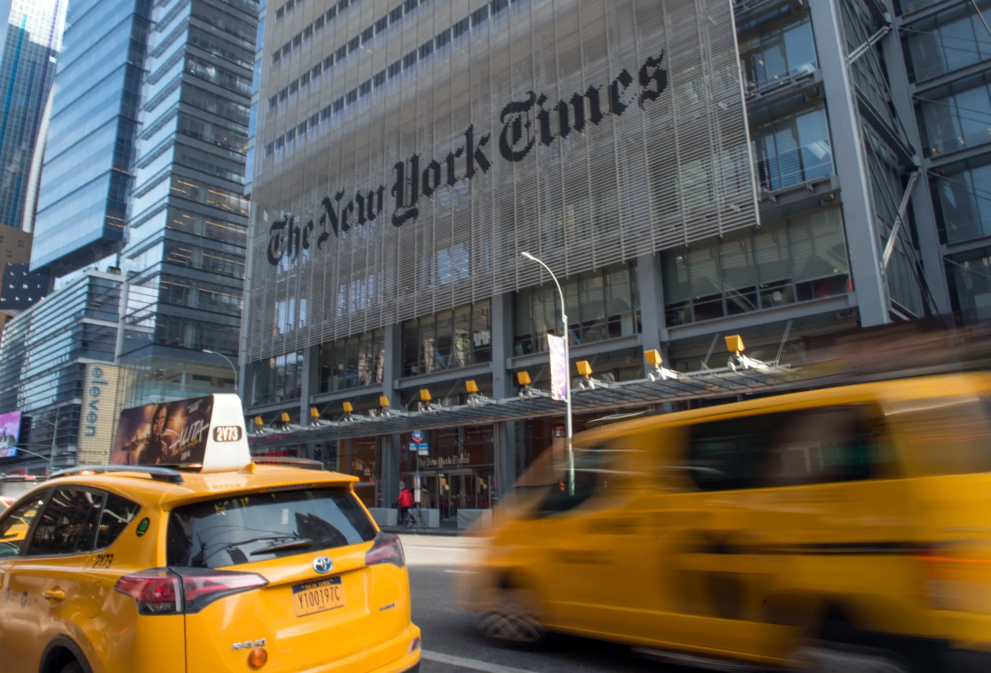 Taxis pass in front of the New York Times Co. headquarters in New York.
