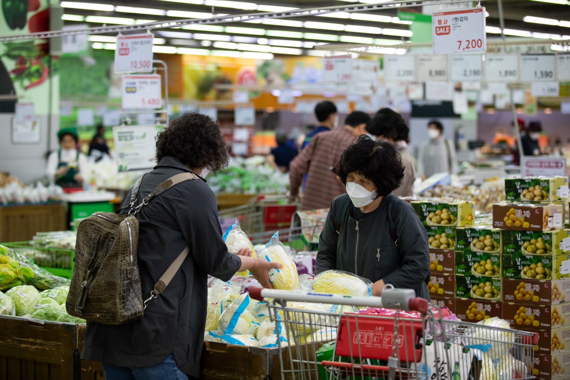 Customers check cabbages at a Hanaro Mart supermarket in Seoul on May 14.