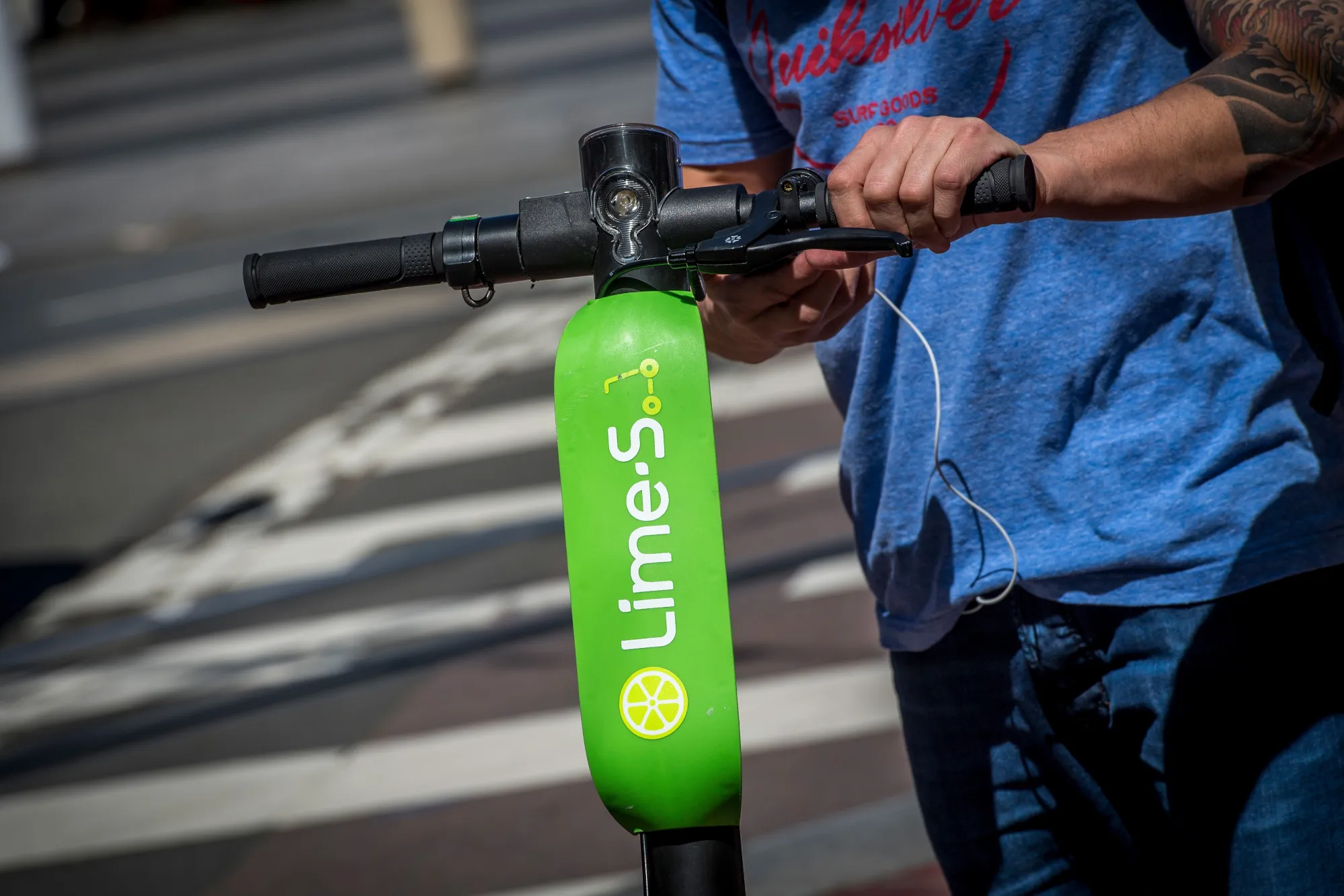 A person unlocks a Lime scooter&nbsp;in San Francisco, Calif.