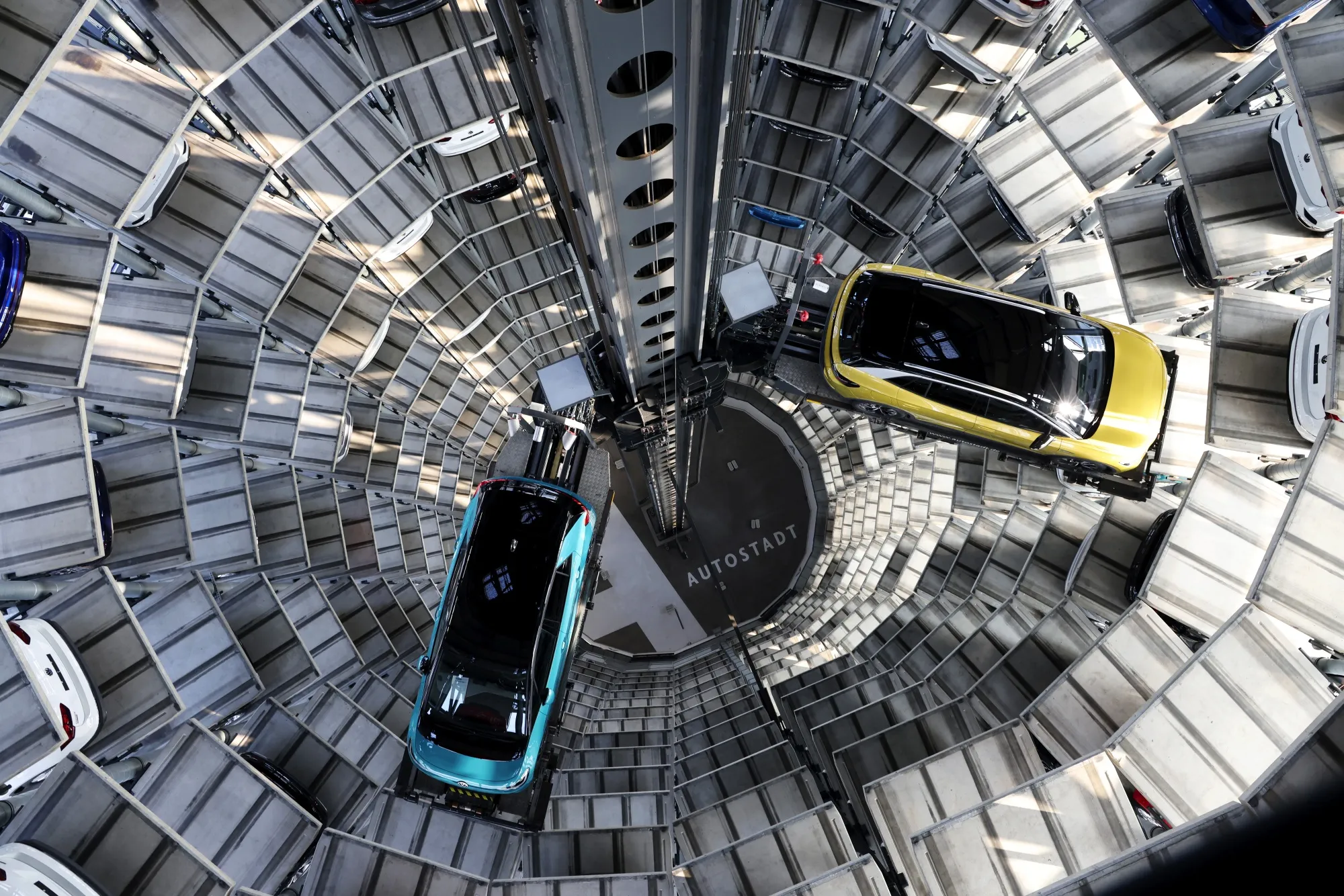 A Volkswagen ID.3 EV, left, and a Volkswagen ID.4 EV inside the Volkswagen AG (VW) delivery tower, in Wolfsburg.&nbsp;