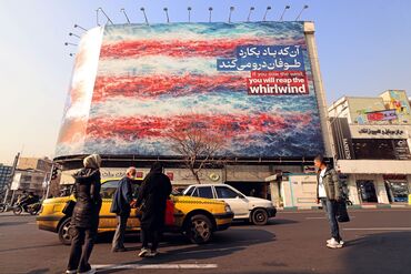 Commuters pass an anti-US billboard in Tehran.