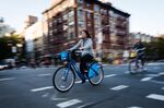 A cyclist rides a Citi Bike in the East Village neighborhood of New York.