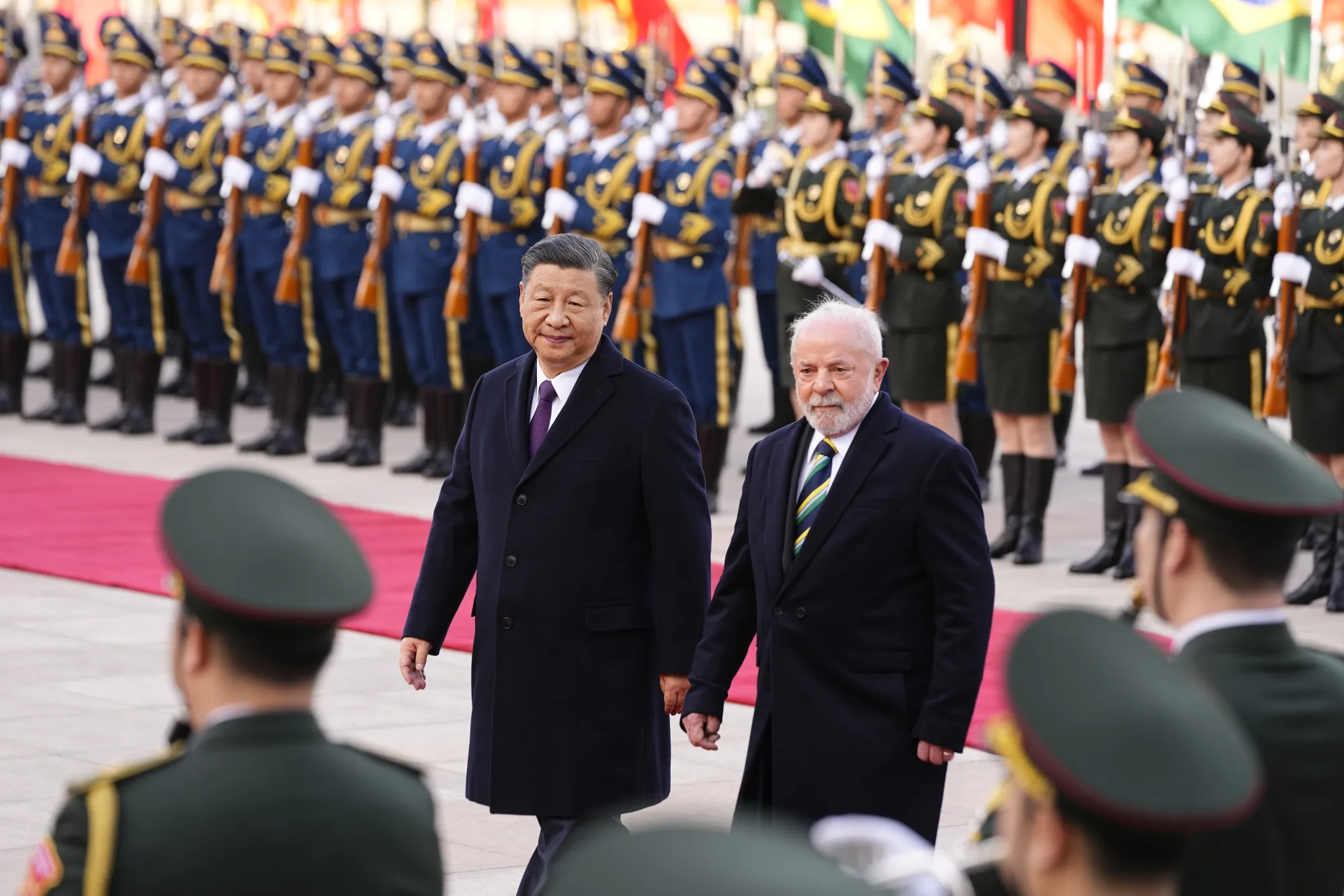 Luiz Inacio Lula da Silva, right, with Xi Jinping, inspects an honor guard in Beijing, on April 14.