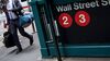 A pedestrian walks past the Wall Street subway station near New York Stock Exchange.