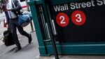 A pedestrian walks past the Wall Street subway station near New York Stock Exchange.