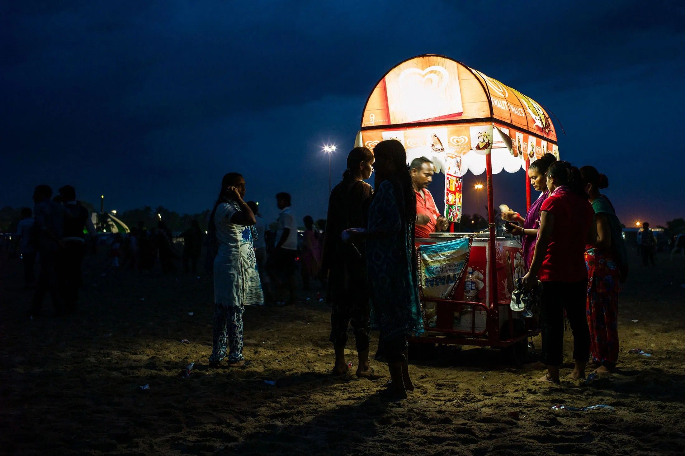 Bloomberg Photo Service 'Best of the Week': A vendor sells ice-cream to customers on Marina Beach in Chennai, Tamil Nadu, India, on Sunday, July 20, 2014. Optimism about a revival in Asia’s third-largest economy is rising after the landslide election victory in May of Prime Minister Narendra Modi, who has pledged to accelerate investment in the nation’s highways, power plants, ports and housing.
