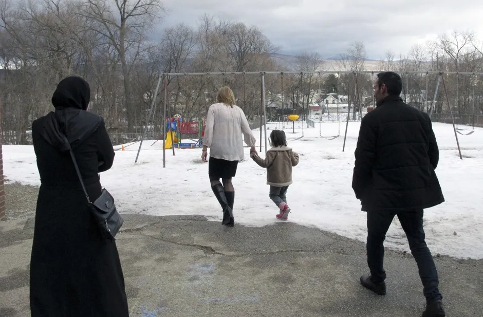 A teacher shows a newly arrived refugee family around a school in Rutland, Vermont.