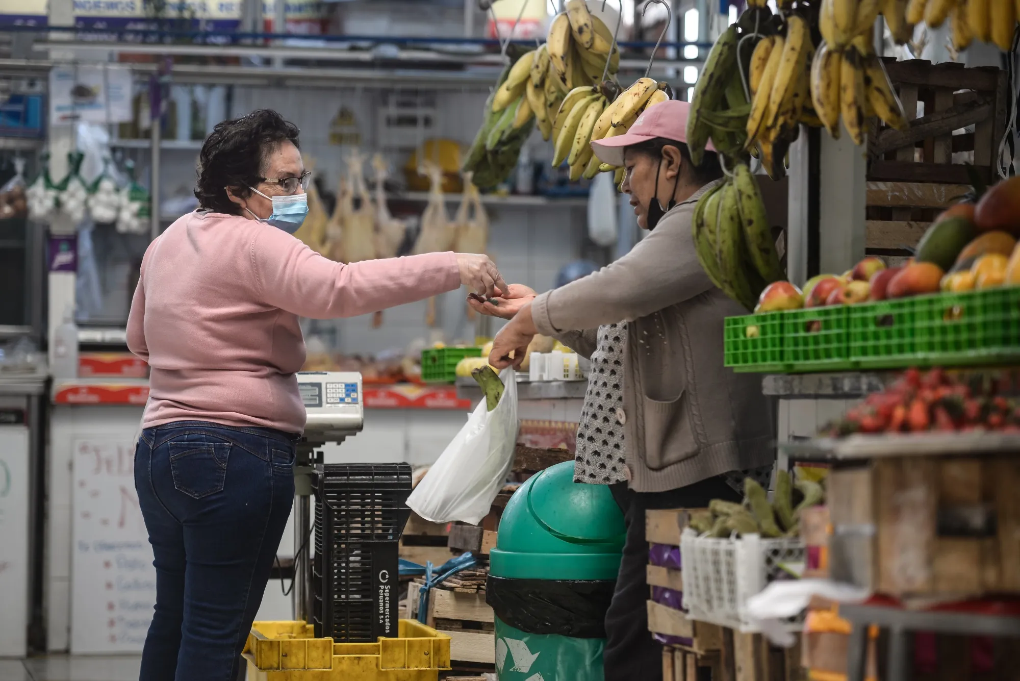 A shopper purchases produce at a market in Lima, Peru, on May 12.