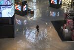 A security guard wears a protective mask as he stands in a nearly empty shopping mall on February 22, 2020 in Beijing.