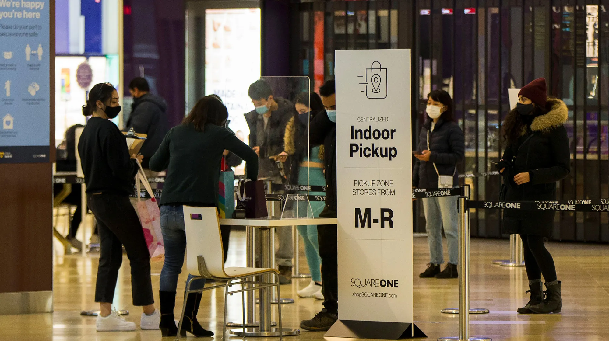 People line up to pick up their online purchased items at a shopping center in Mississauga, Canada, on Jan. 12.