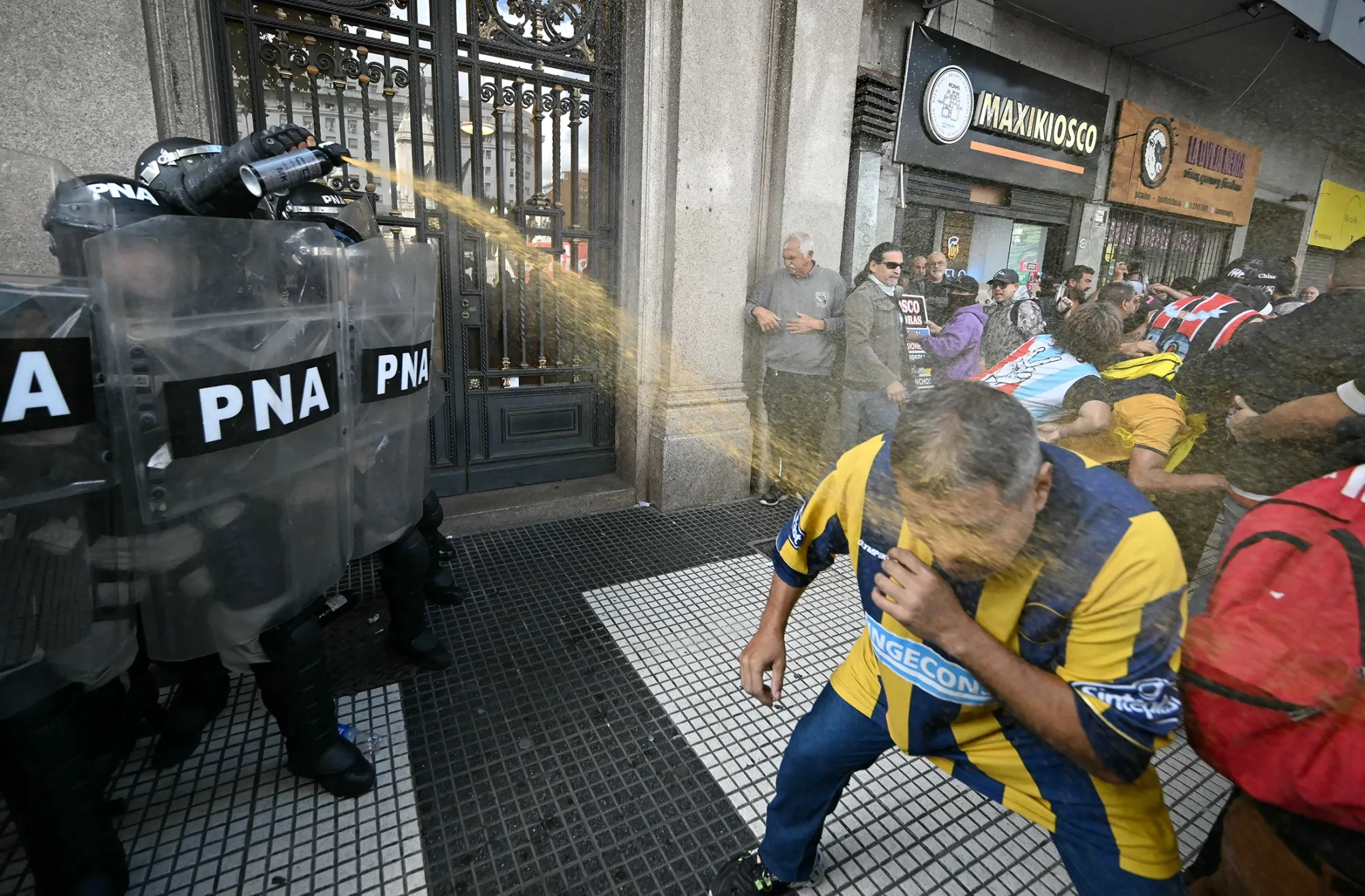 A police officer uses pepper spray&nbsp;during a protest of pensioners supported by football fans against the government of President Javier Milei in Buenos Aires on March 12.