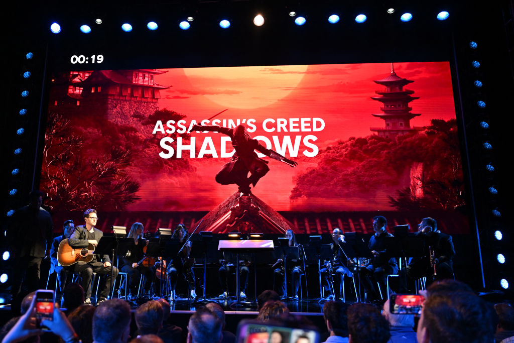 "Assassin's Creed SHADOWS" is seen on screen at the Ubisoft Forward 2024 showcase presentation at the Belasco Theater in Los Angeles, California on June 10, 2024. (Photo by Robyn Beck / AFP) (Photo by ROBYN BECK/AFP via Getty Images)