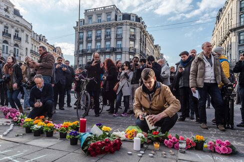People light candles in Brussels on Tuesday.