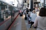 Passengers prepare to embark an East Japan Railway Co. (JR East) Shinkansen bullet train at the Tokyo Station in Tokyo.
