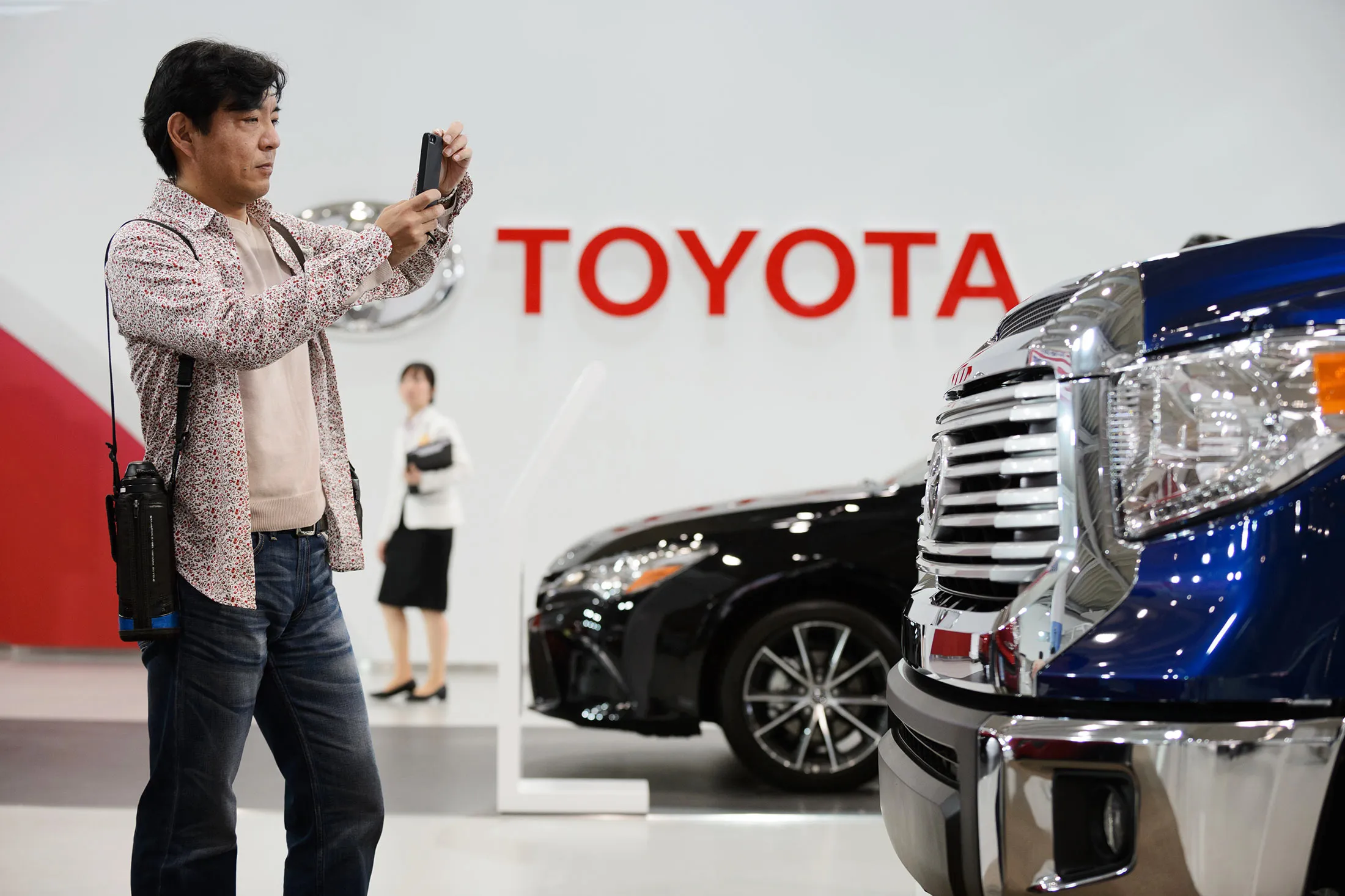 A visitor takes a photograph of a Toyota Motor Corp. Tundra truck on display at the company's Mega Web showroom in Tokyo, Japan, on Tuesday, May 5, 2015.
