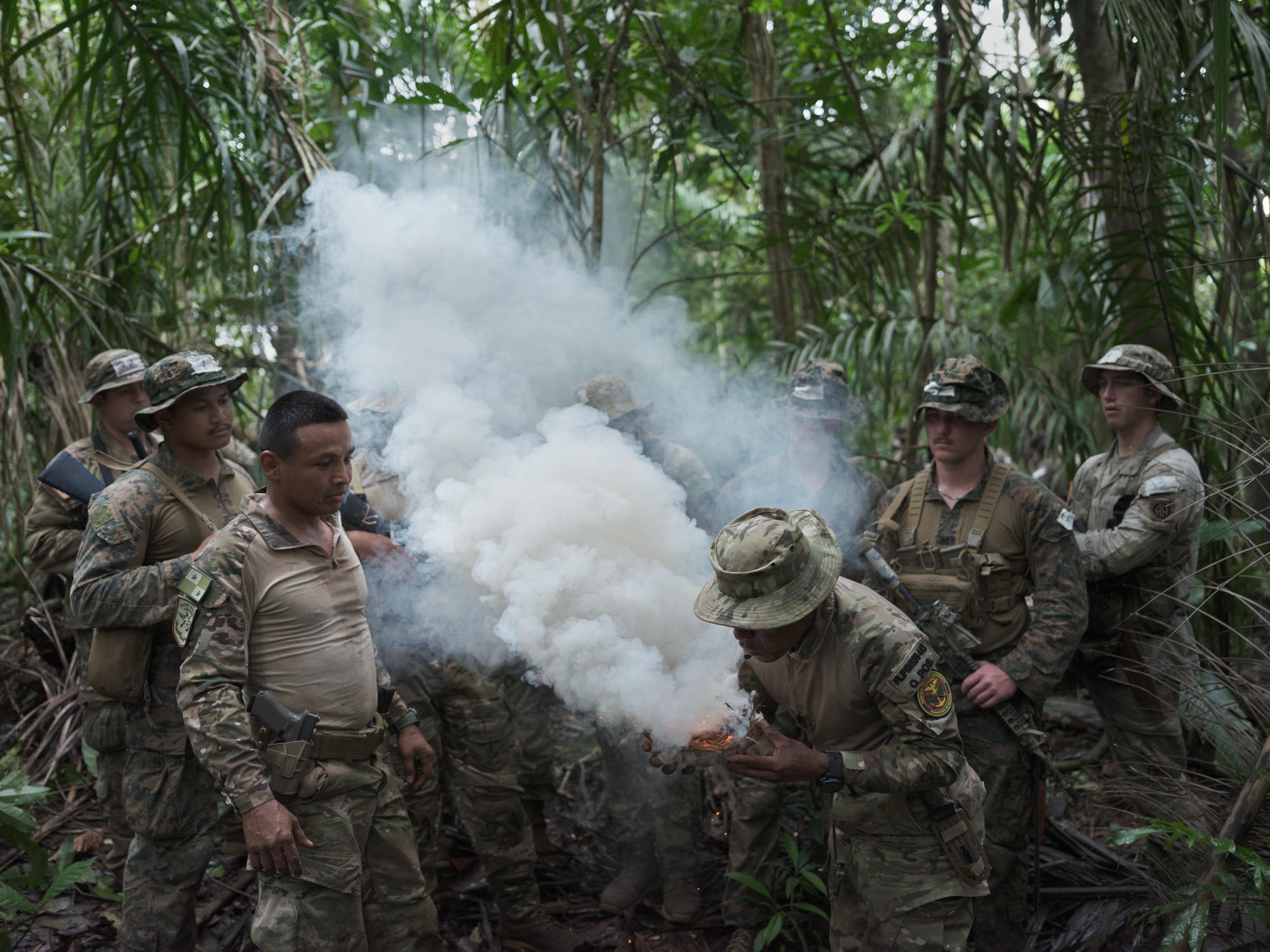 Commander Albis Fajardo of Panama’s National Aeronaval Service (SENAN) demonstrates how to start a fire using a coconut husk during a training exercise. Photographer: Luis Antonio Rojas/Bloomberg