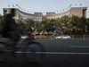 A man rides a bicycle past the People's Bank of China headquarters in Beijing, China, on Monda