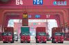 This photo taken on July 11, 2019 shows containers being loaded onto trucks at the container port in Qingdao, China's eastern Shandong province. - China's economy grew at its slowest rate in nearly three decades in the second quarter, according to an AFP survey of analysts, hit by the US-China trade war and weakening global demand. (Photo by - / AFP) / China OUT (Photo credit should read -/AFP/Getty Images)