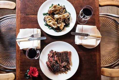 Galician beef sirloin served with onions, pickled walnut, pink fir potatoes, and Tunworth, a cow’s-milk cheese, at Kitty Fisher’s.