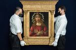 Auction house employees holding Sandro Botticelli’s The Man of Sorrows.