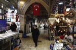 A pedestrian walks past retail stores in the Grand Bazaar in Istanbul.
