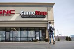 A shopper walks toward a GameStop Corp. store in Ottawa, Illinois, U.S., on Monday, April 1, 2019. GameStop is scheduled to release earnings figures on April 2.