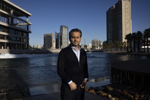 A portrait of Augusto Martins in front of the wave pool. 