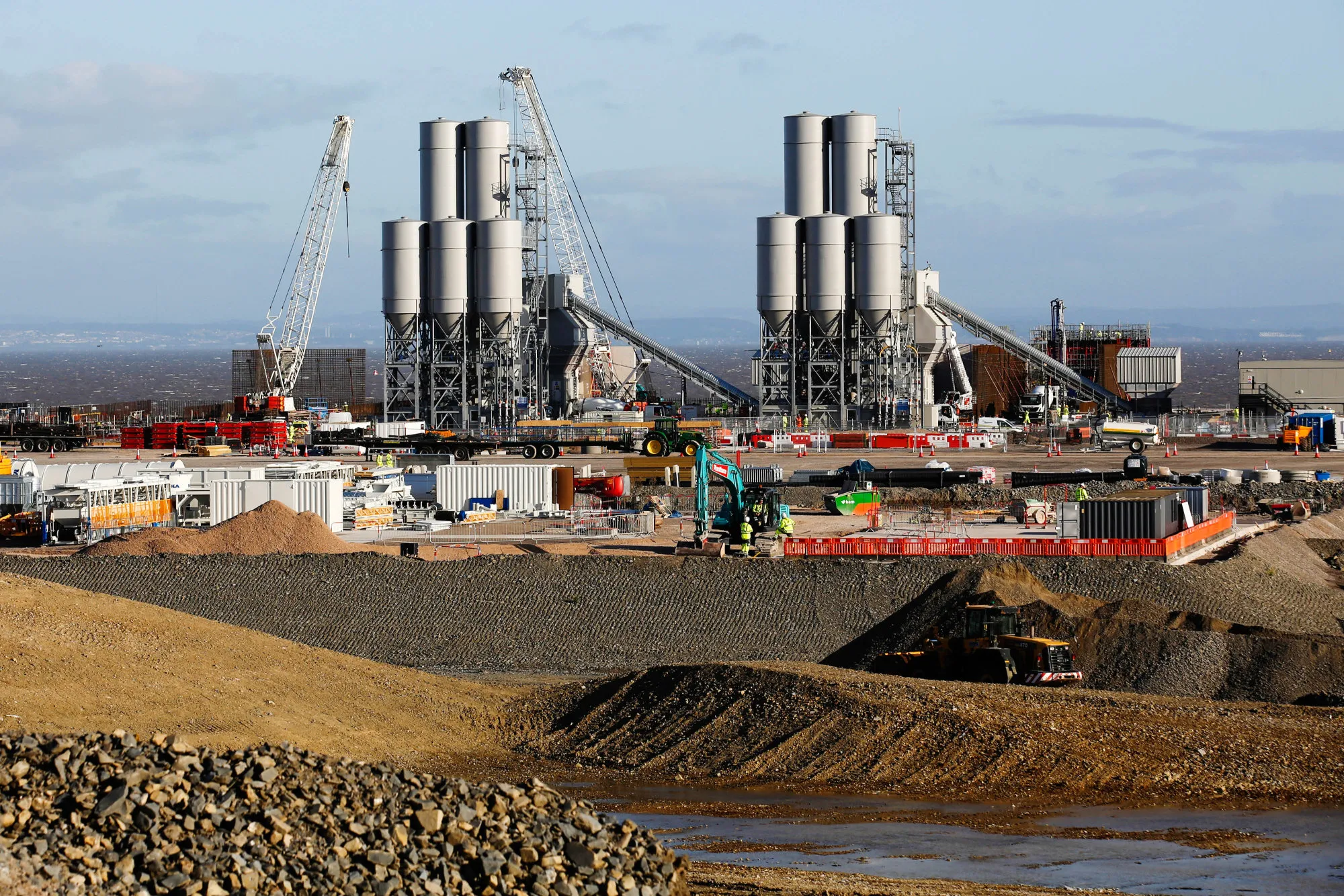 The concrete batching plant stands on the horizon as work recommences at the Hinkley Point C nuclear power station, operated by Electricite de France SA's (EDF), near Bridgwater, U.K., on Friday, Sept. 16, 2016.
