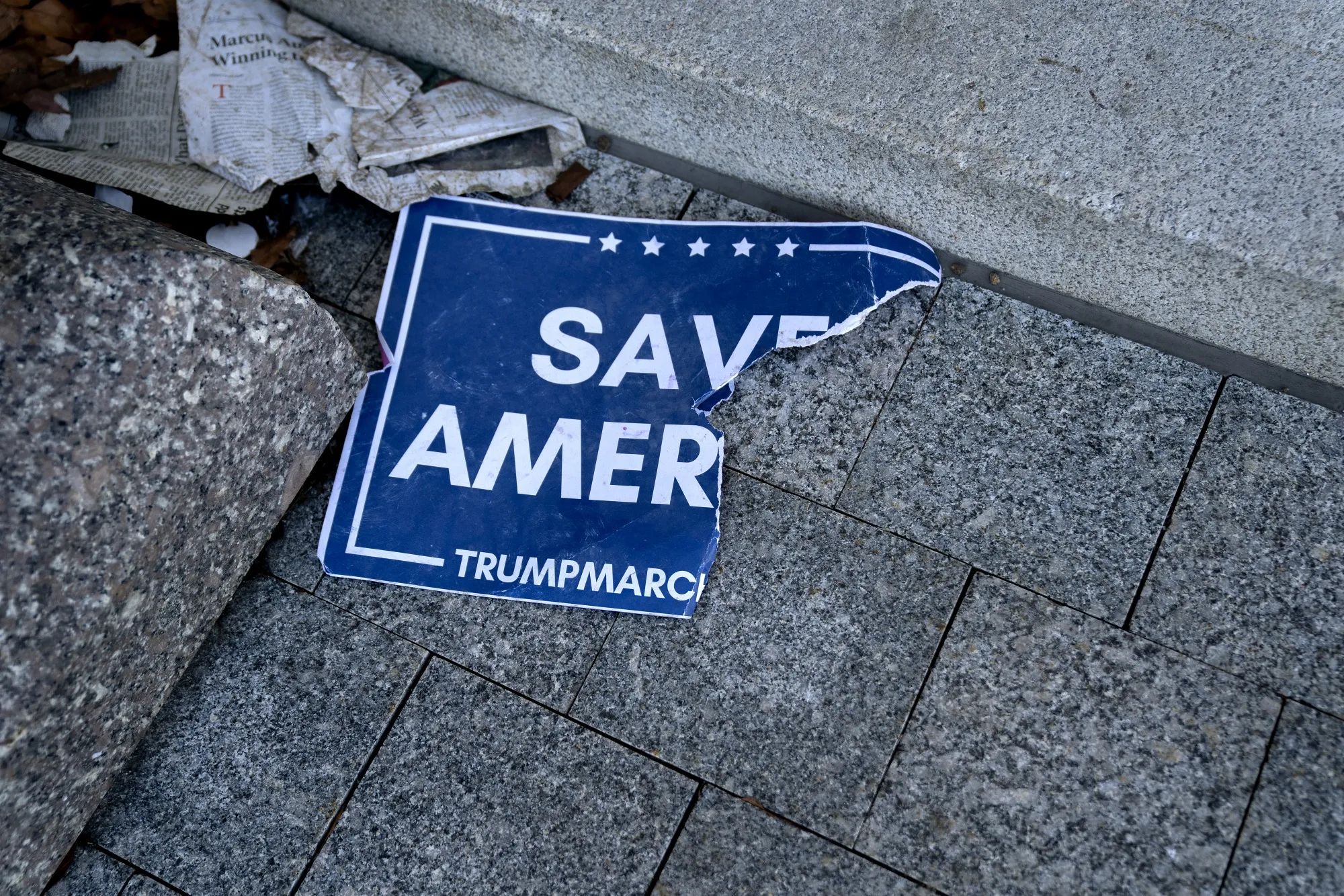 A torn "Save America" sign outside the U.S. Capitol in Washington, D.C., on Jan. 7.&nbsp;