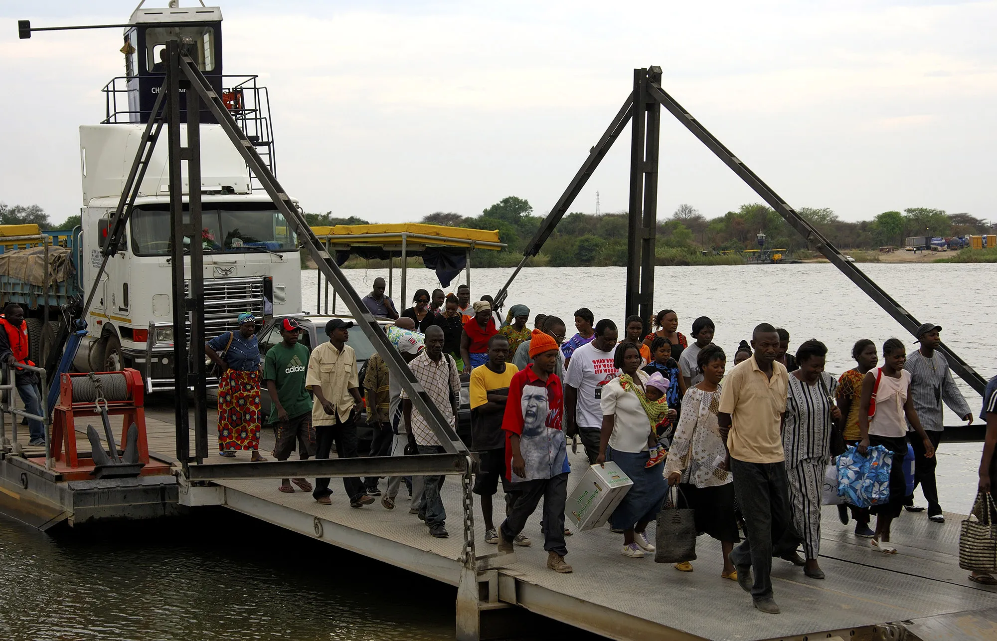Passengers desembarque from a river ferry crossing the Zambezi river at the border station for Botswana and&nbsp;Zambia, in Kazungula, Botswana in 2006.