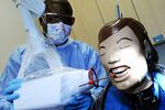 A dental assistant student practices taking an X-ray in Boston.