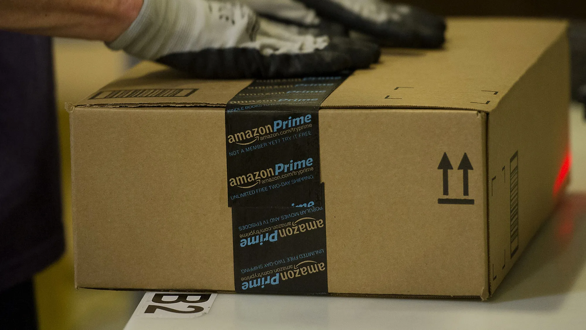 An employee seals a box at the Amazon.com Inc. fulfillment center in Phoenix, Arizona.
