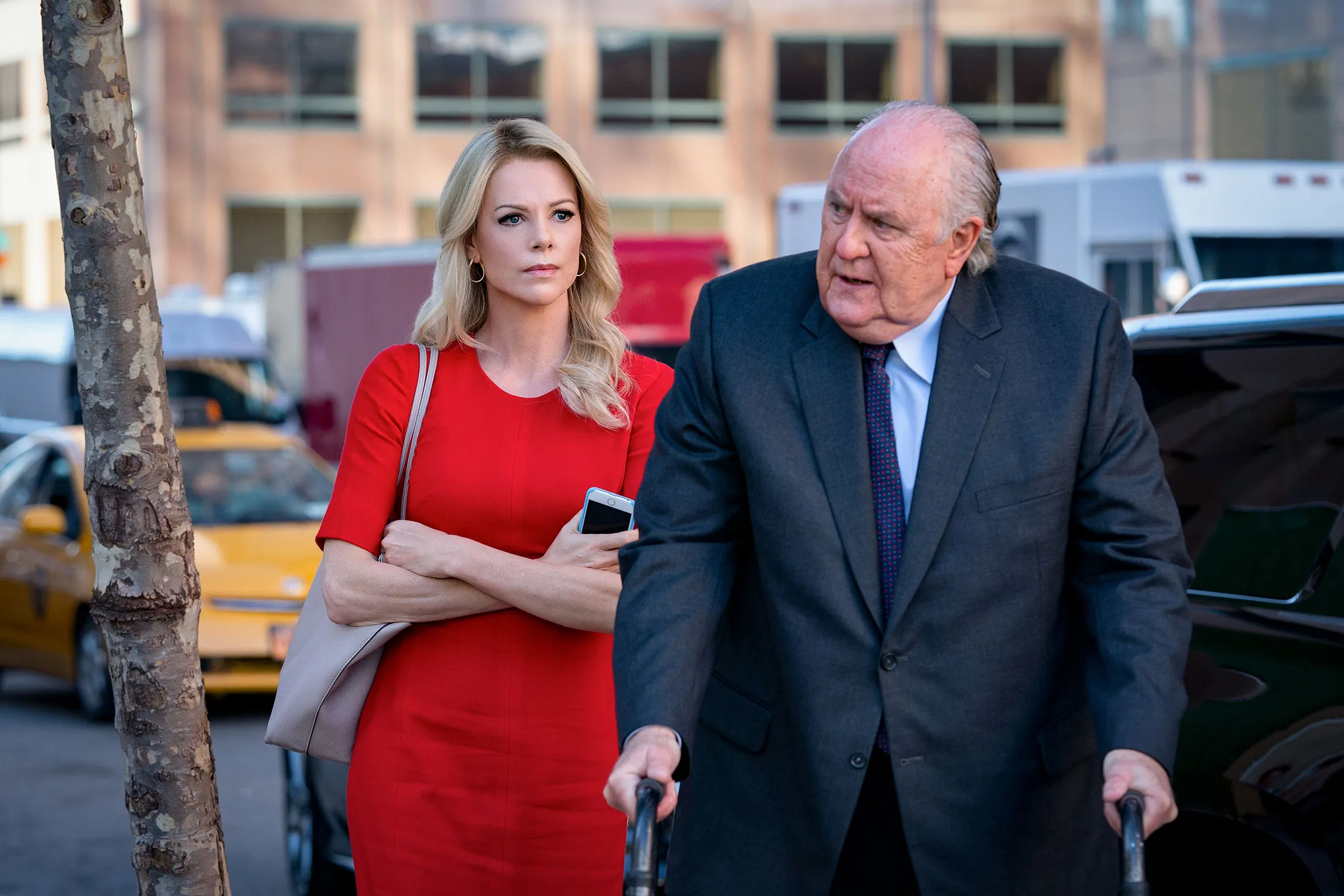 Charlize Theron, as Megyn Kelly, and John Lithgow, as Roger Ailes, in Bombshell.