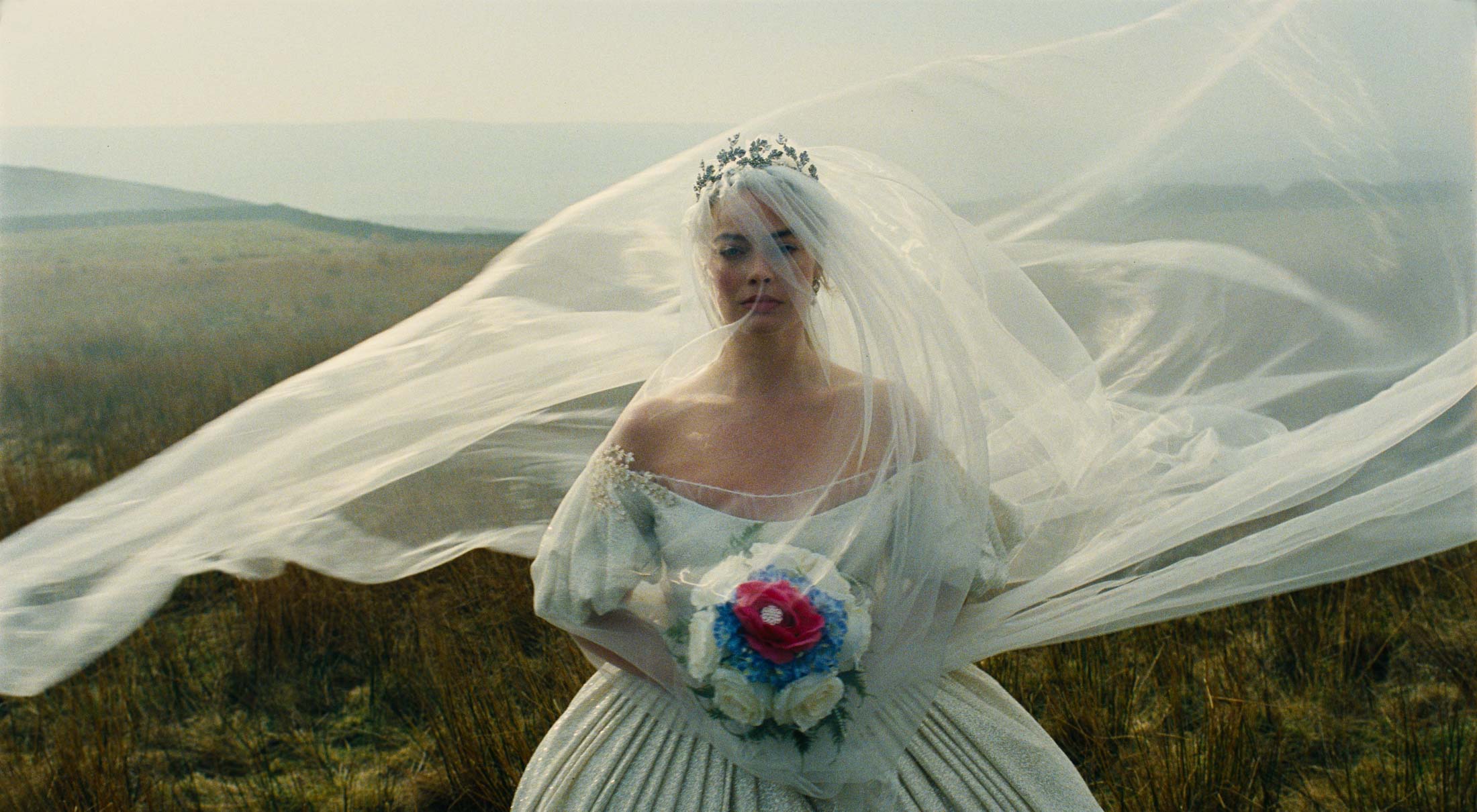 Margot Robbie stands in an ornate wedding dress in "Wuthering Heights."