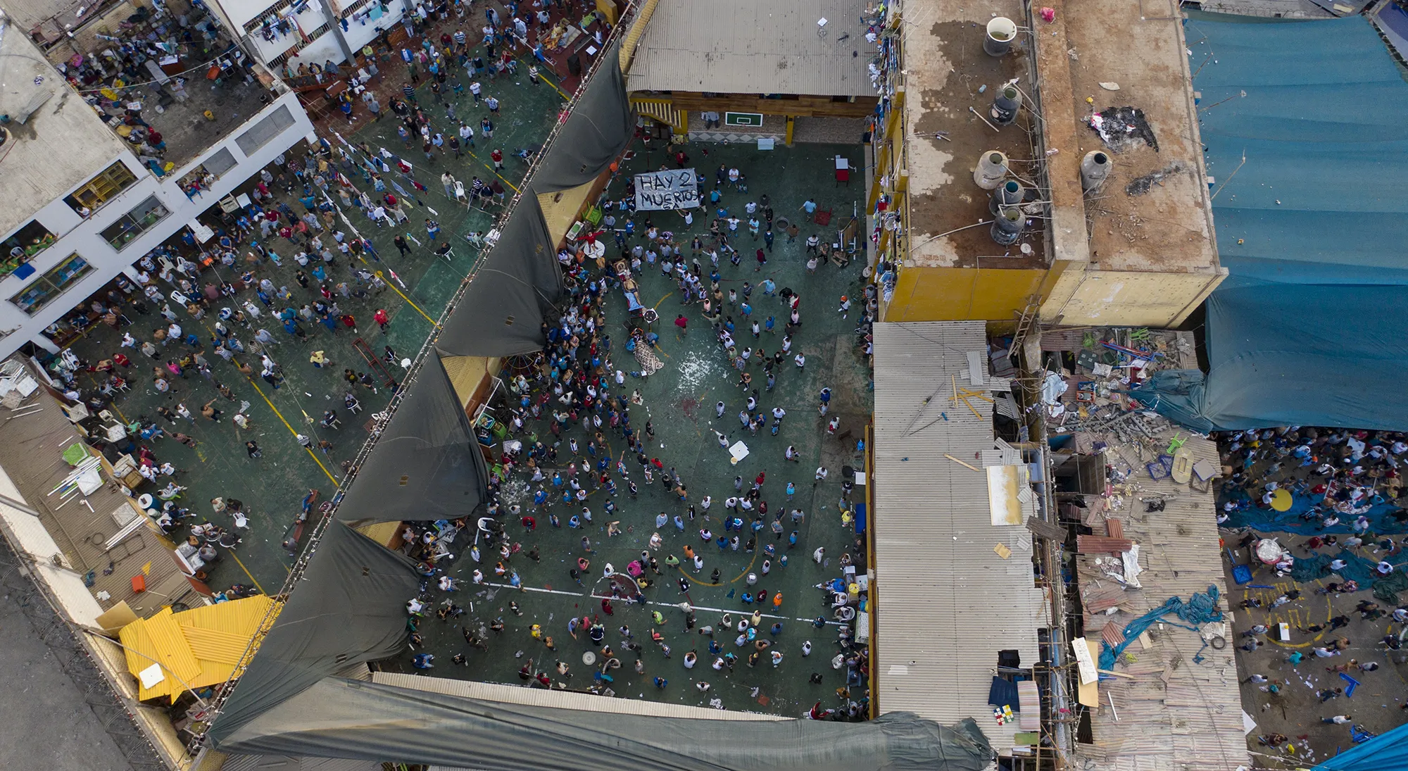 Inmates gather around the corpses of other inmates during a riot in Miguel Castro Castro jail in Lima on April 27.