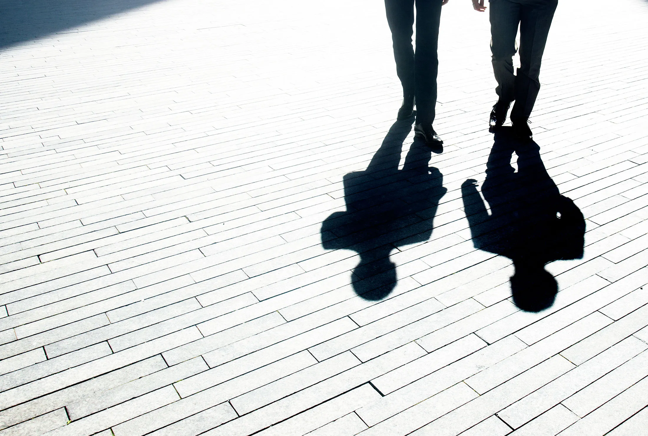 Two businessmen walking through the city.