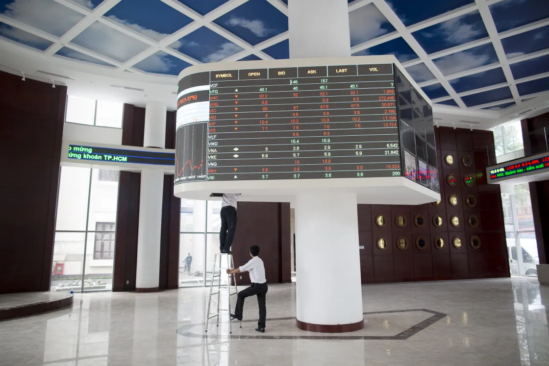 Employees inspect an electronic stock board inside the new Ho Chi Minh Stock Exchange (HOSE) in Ho Chi Minh City, Vietnam.