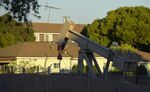 An oil pump-jack runs near homes in the Los Angeles neighborhood of Wilmington.