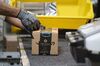 An employees places a label on a box at the Amazon.com Inc. fulfillment center in Baltimore, Maryland, U.S., on Tuesday, April 30, 2019. Amazon.com will spend $800 million in the current quarter to reduce delivery times for top customers to one day from two, trying to revive its main e-commerce franchise and ward off greater competition.