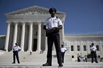 U.S. Supreme Court police officers stand outside of the court during a demonstration in Washington, D.C., on Oct. 4. 